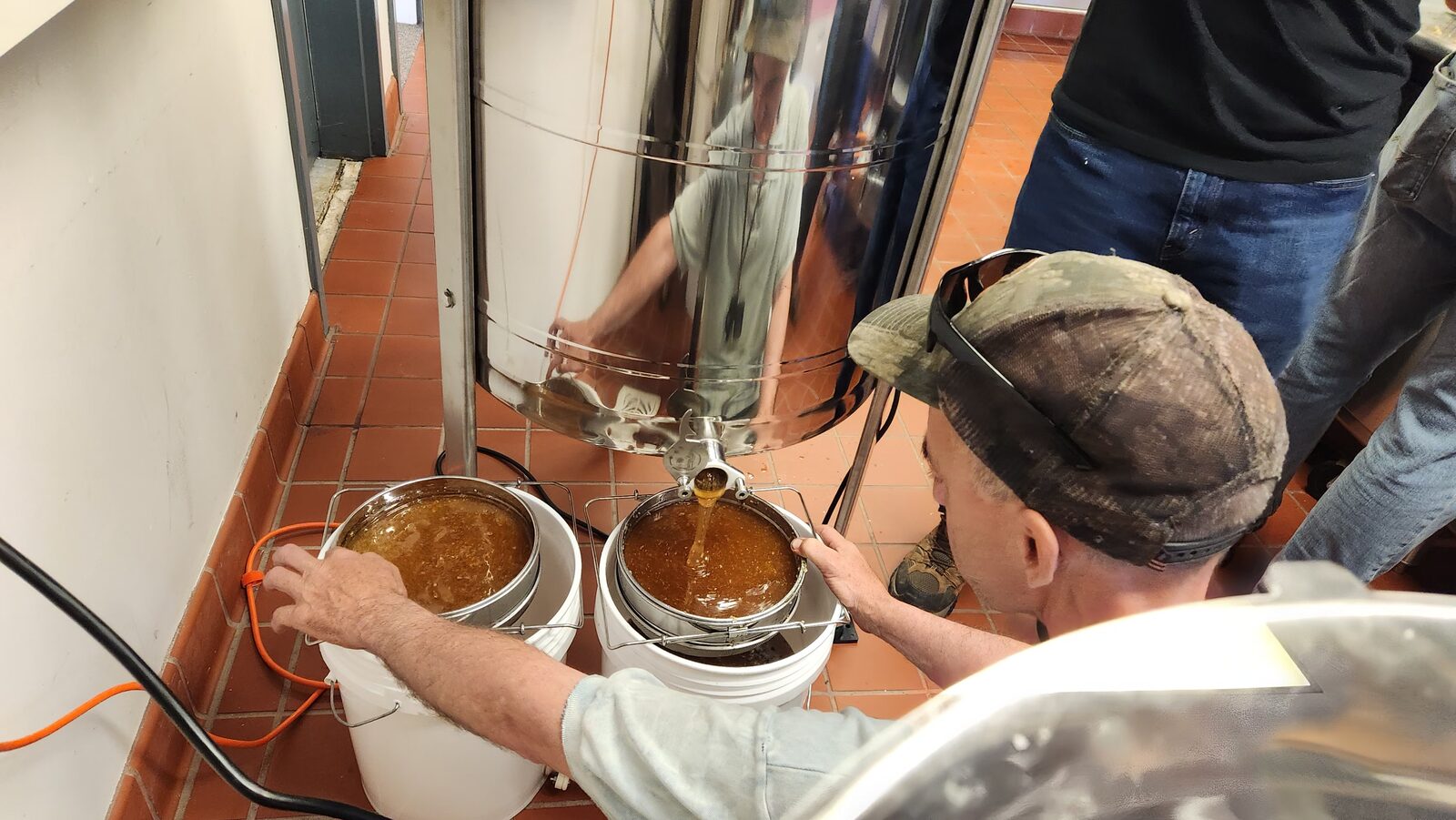 Filling buckets with fresh honey from the extractor